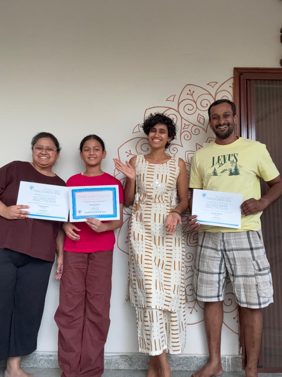 Likhitha at Access Bars graduation holding certificates with fellow practitioners