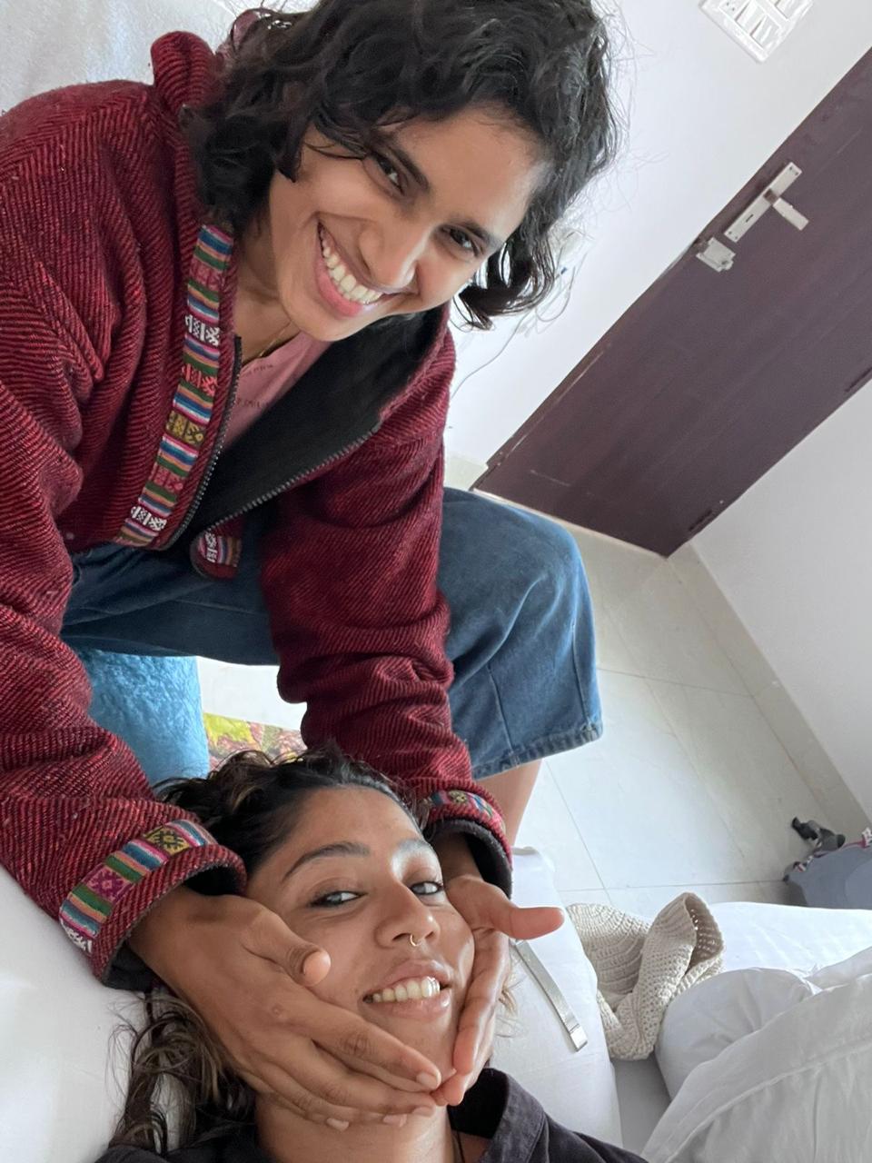 Likhitha and a client sharing a joyful, laughing moment during a session
